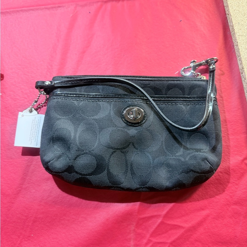 Coach Park Signature Medium Wristlet. PRK SIG MED WRST," which stands for Park